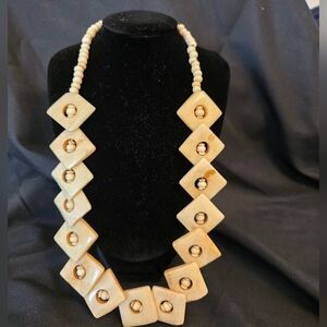 Unique handcrafted necklace featuring a mix of square and round bone beads